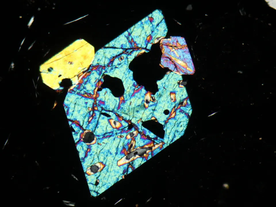 Olivine crystal in a basalt thin section under cross-polarised light